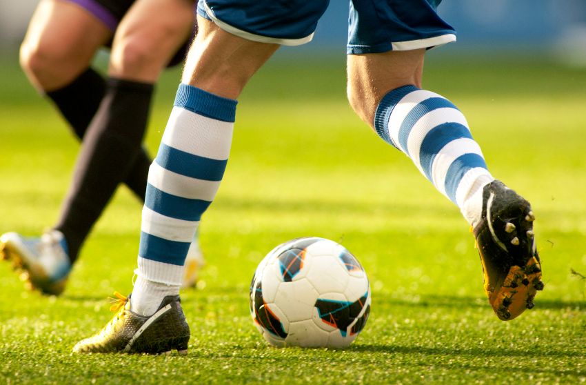 Soccer players wear long football socks