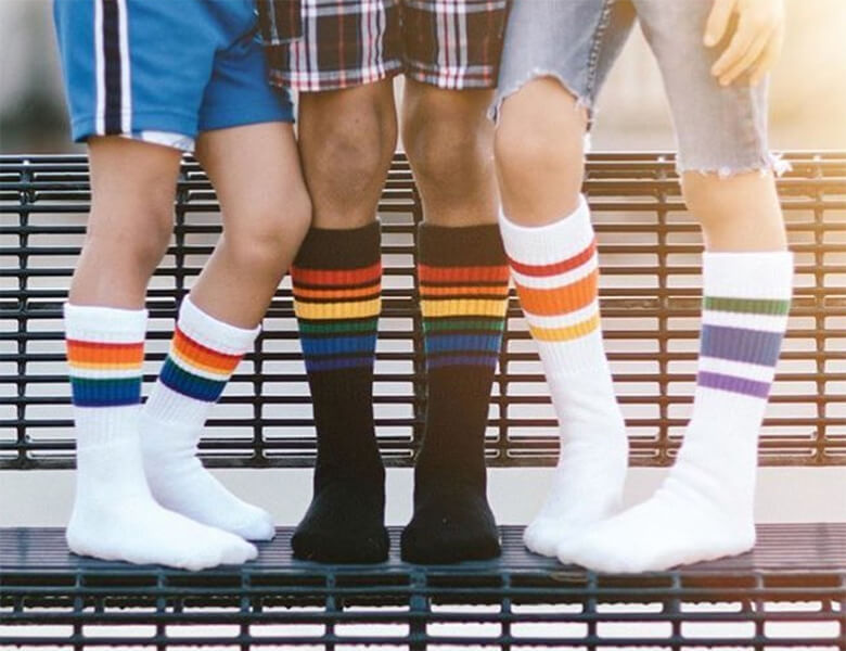 Three children wearing white custom tube socks